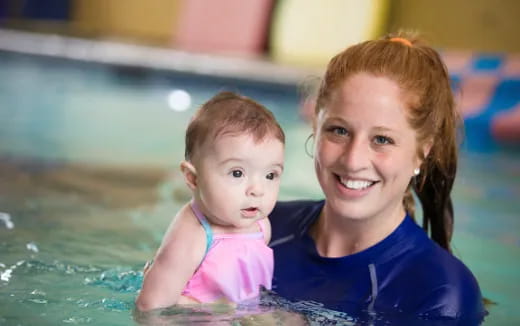 a person and a baby in a pool