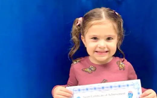 a girl holding a piece of paper