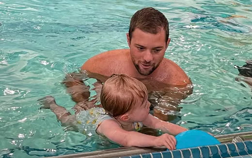 a man and a baby in a pool
