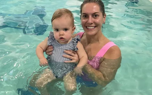 a person and a baby in a pool