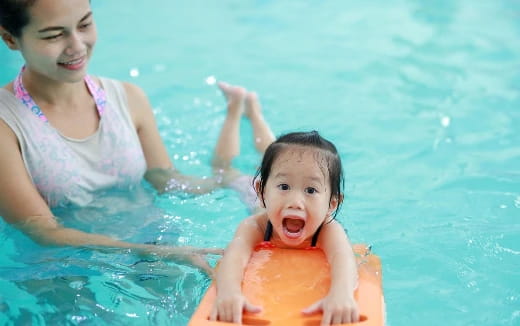 a person and a child in a pool