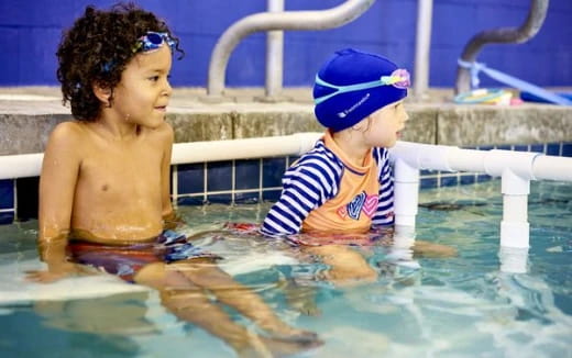 a couple of children in a pool
