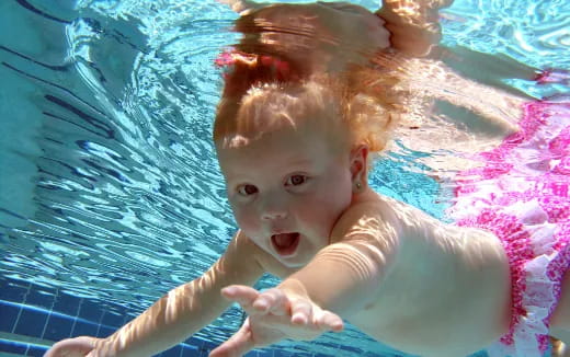 a baby in a pool