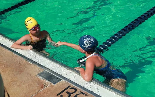 a couple of women in a pool