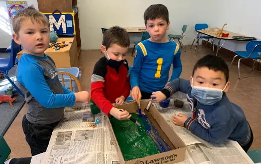 a group of boys sitting at a table