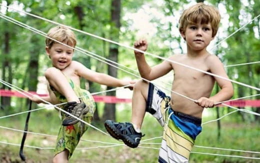 two boys in a swing