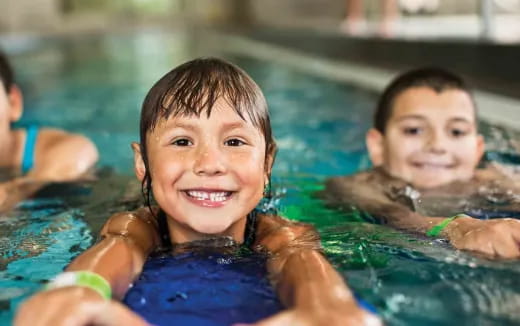 a couple of children in a pool