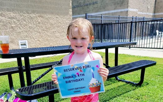 a girl holding a sign