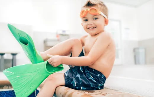 a boy sitting on a toy