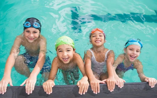 a group of kids in swimsuits
