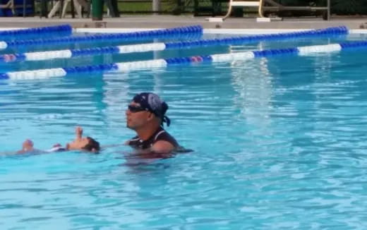 a group of people swimming in a pool