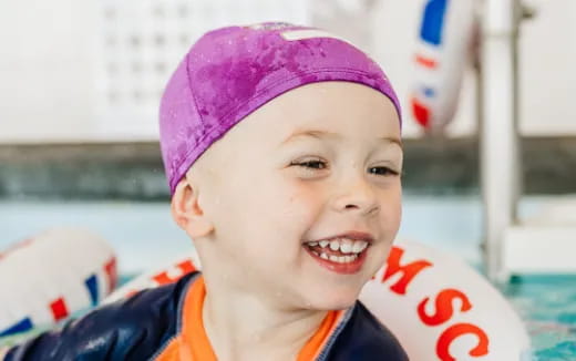 a child wearing a pink hat