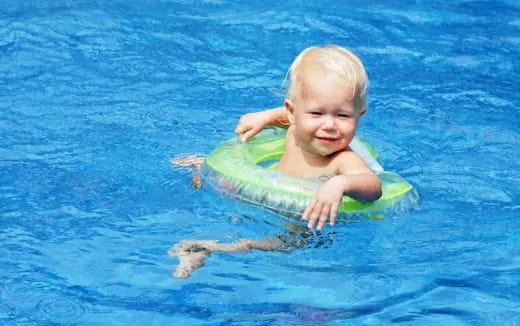 a baby in a pool