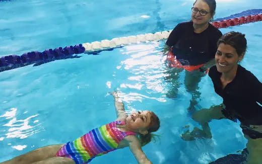 a dog and a person in a pool