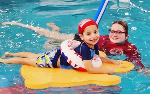 a person and a child in a pool