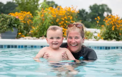a person and a baby in a pool