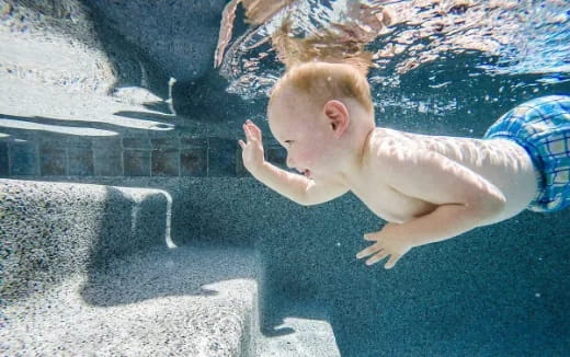 a baby lying on a blanket