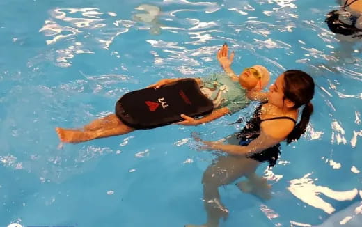 a couple people in a pool