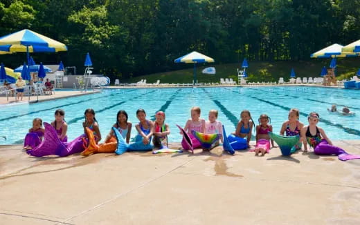 a group of people sitting on a pool