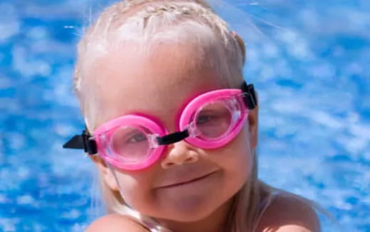 a woman wearing pink goggles