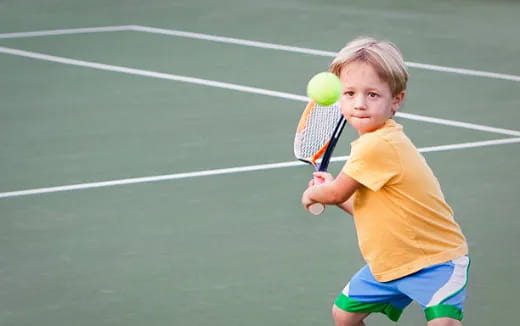 a boy playing tennis