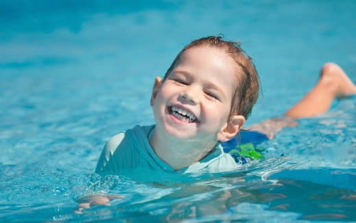 a boy swimming in water