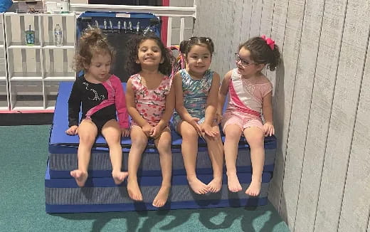 a group of children sitting in a play structure