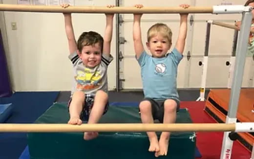 two boys on a bar