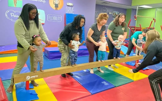 a group of people playing on a mat