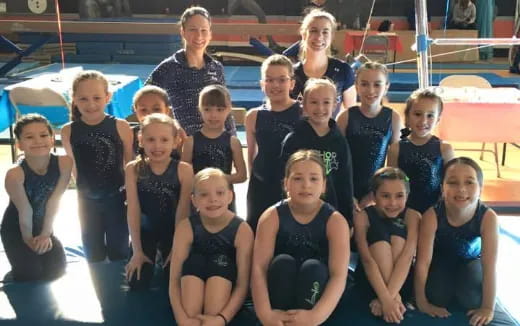 a group of women in swimsuits posing for a photo