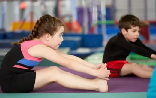 a person and a boy in a gym