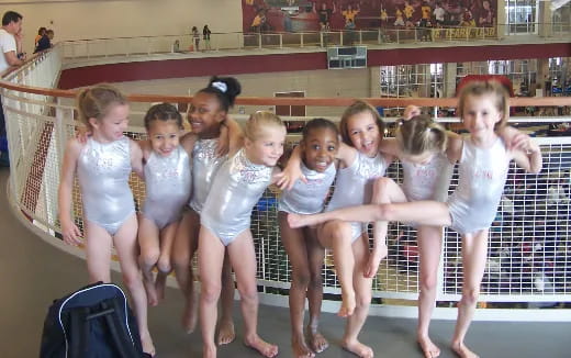 a group of girls in white dresses