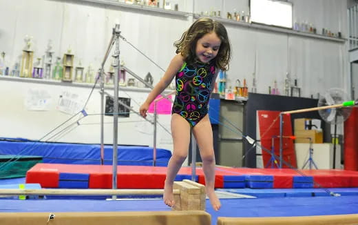 a girl jumping on a trampoline