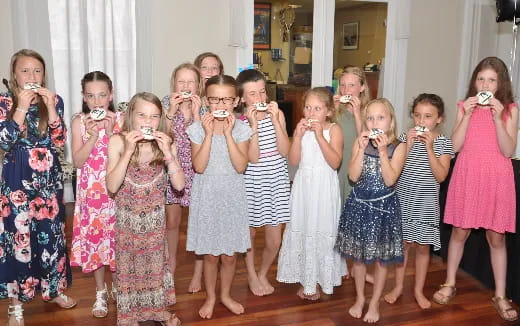 a group of girls holding objects in their hands