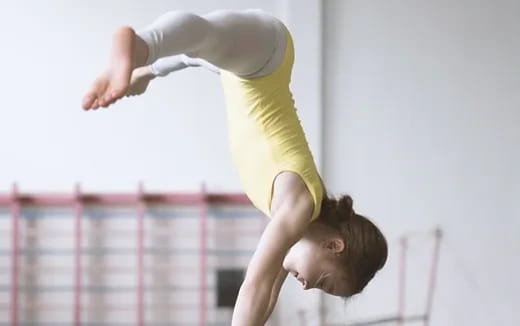 a woman doing a handstand