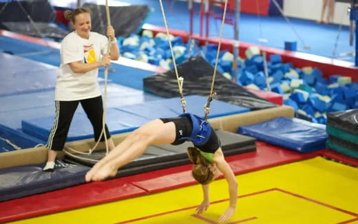 a woman in a pool with a man in a swimsuit