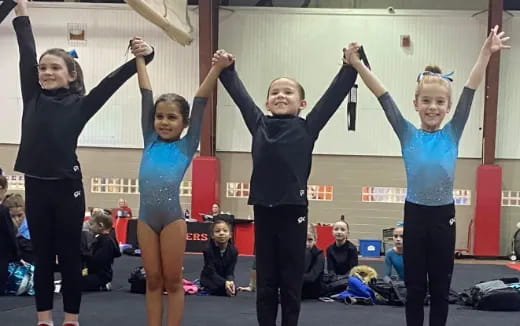 a group of women in leotards posing for a photo