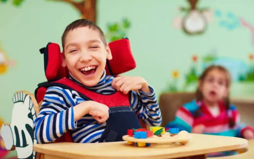a boy and a girl sitting at a table