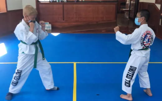 a couple of men in karate uniforms