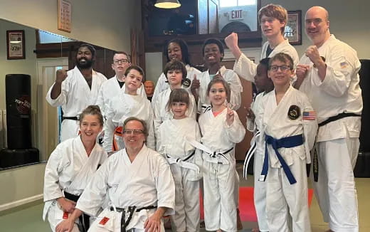 a group of people in white karate uniforms