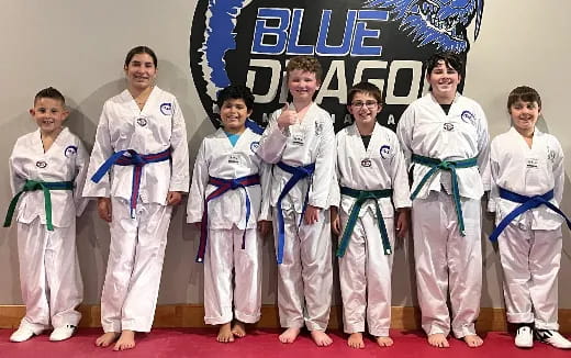 a group of people in karate uniforms