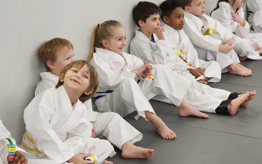 a group of children in white uniforms