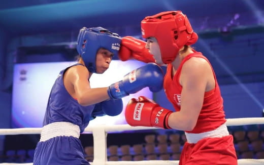 a couple of women wearing boxing gloves