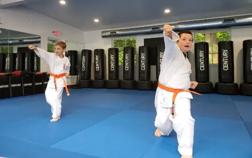 a couple of men in karate uniforms