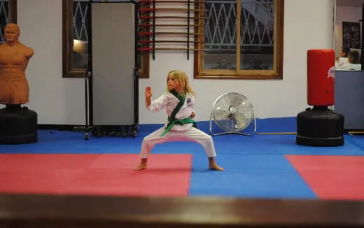 a girl in a karate uniform