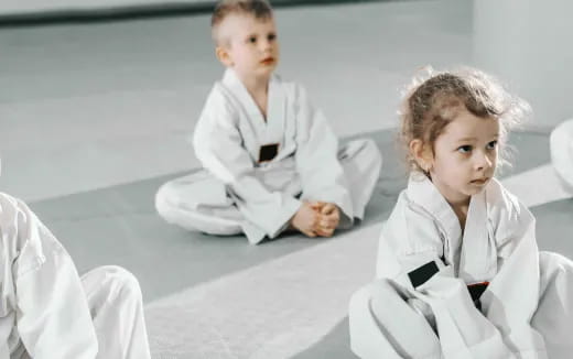 a couple of kids in karate uniforms