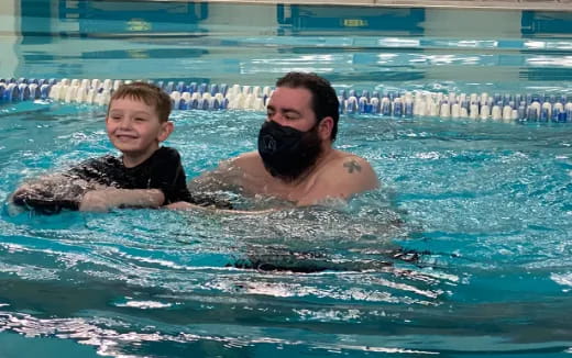 a man and a boy in a pool