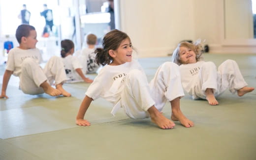 a group of children in karate uniforms