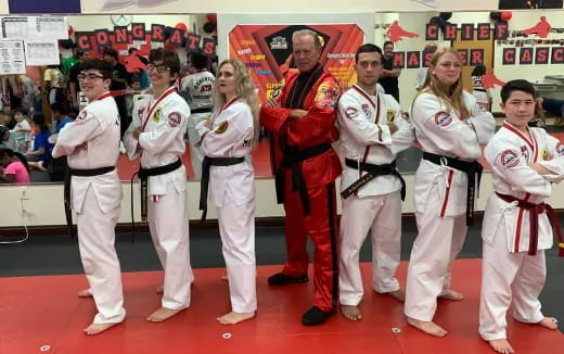 a group of people in karate uniforms