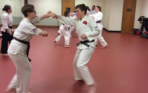 a group of people in karate uniforms